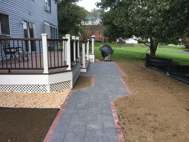 gray paver walkway outlined in red stone