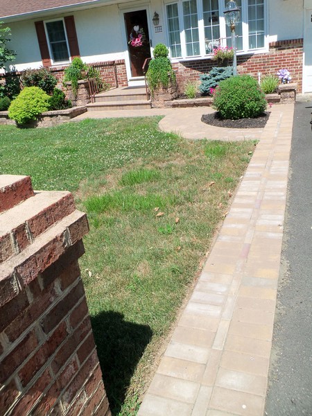 front of home paver walkway and garden retaining wall