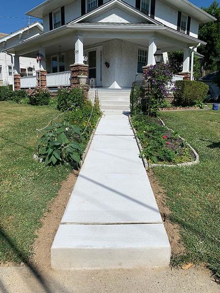 new concrete walkway leading to a house