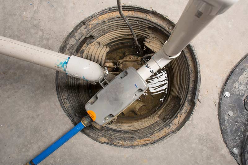 waterproofing sump pump system with PVC pipes and standing water