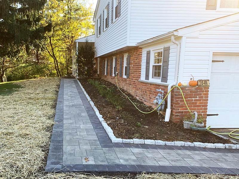 newly installed hardscape paver walkway alongside a home
