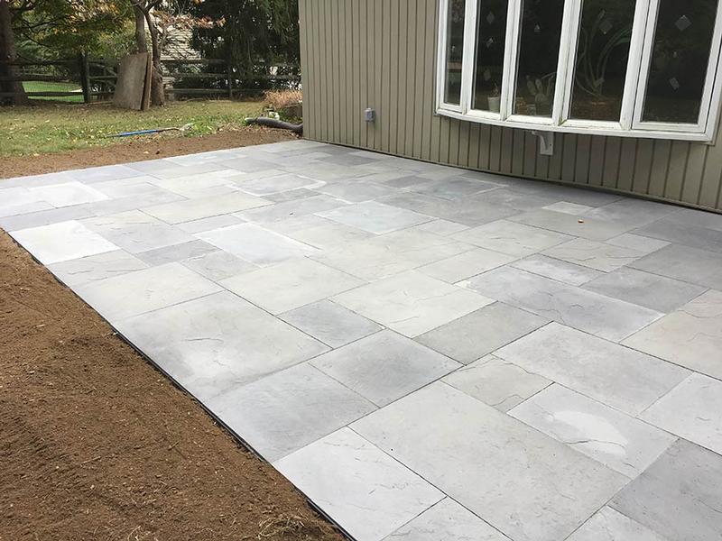 newly constructed light gray flagstone patio